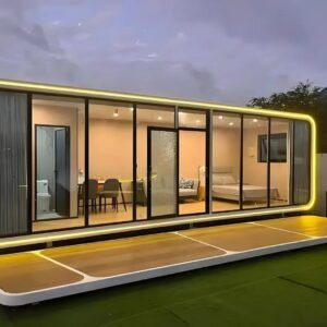 Apple cabin hotel suite with floor-to-ceiling glass walls at night