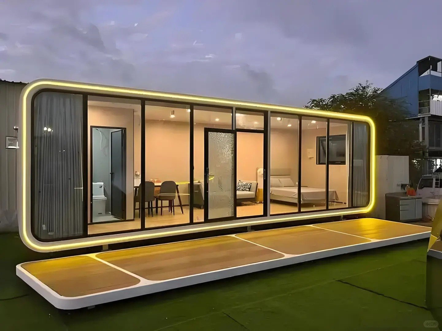 Apple cabin hotel suite with floor-to-ceiling glass walls at night