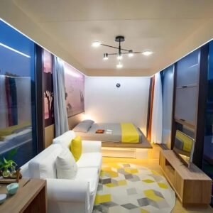 Apple cabin tiny home interior with sofa bed and panoramic glass windows
