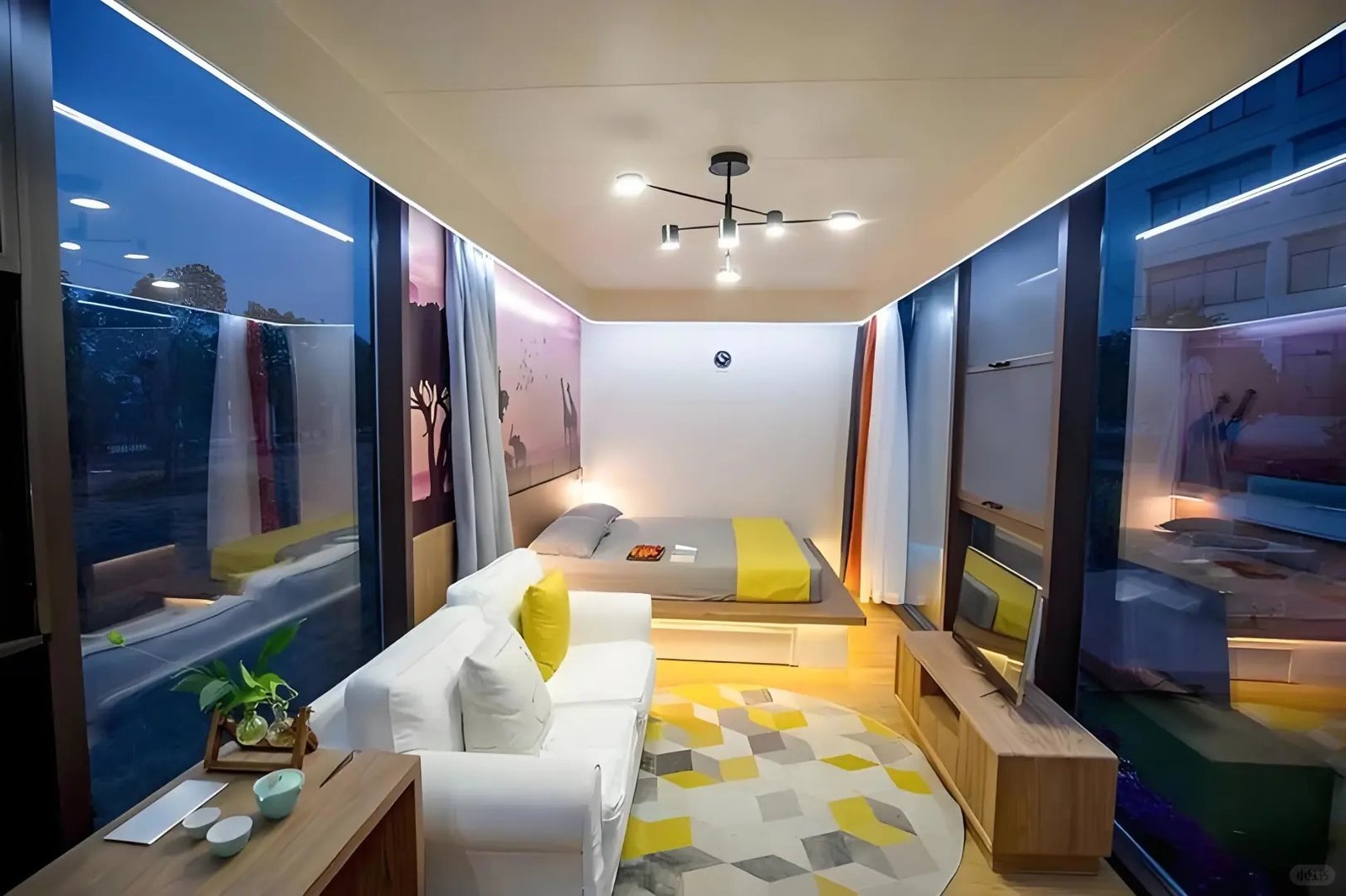 Apple cabin tiny home interior with sofa bed and panoramic glass windows