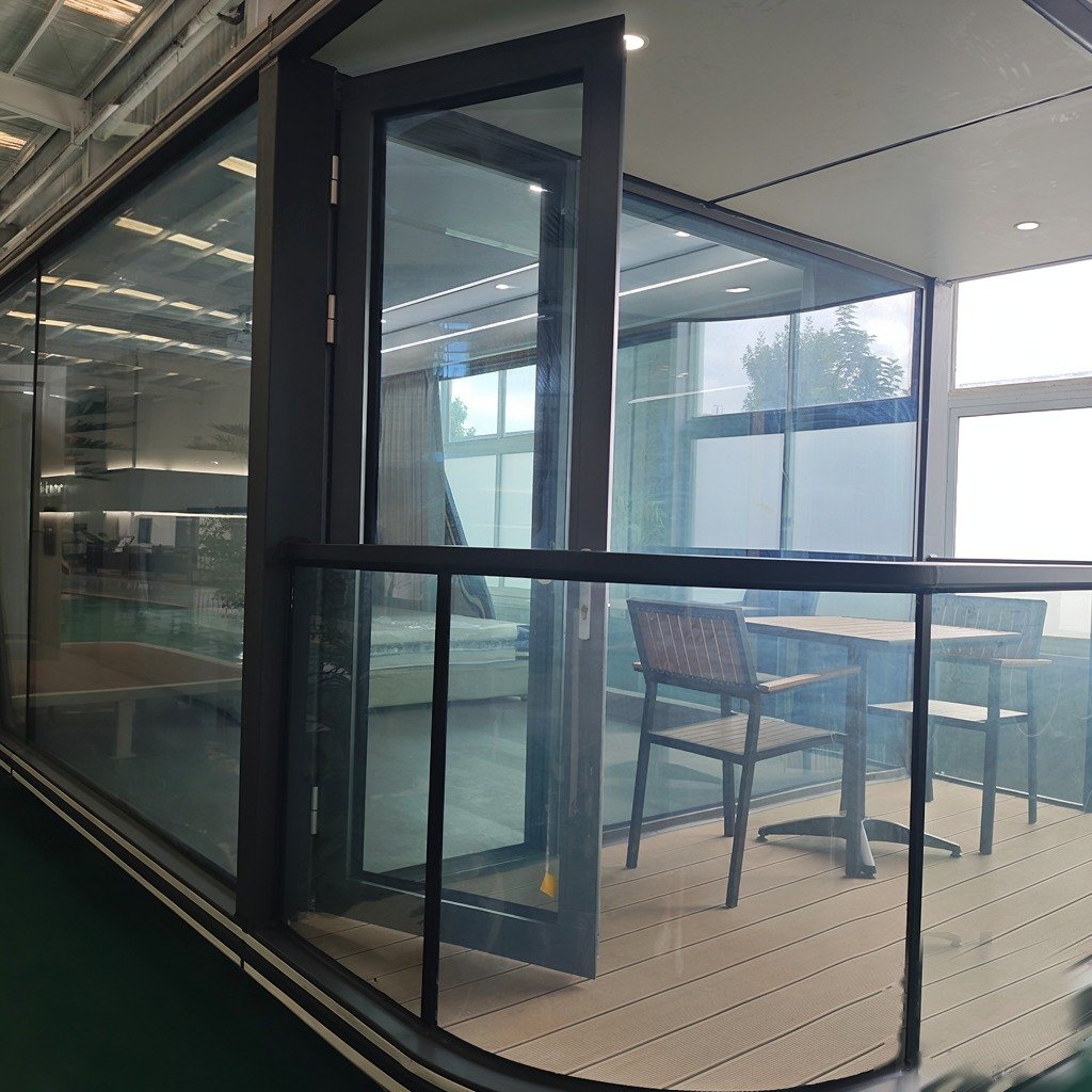 Capsule house balcony with aluminium frame glass door and railing