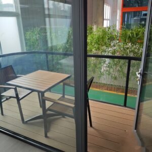 Capsule house hotel room interior with twin beds and curtained glass wall