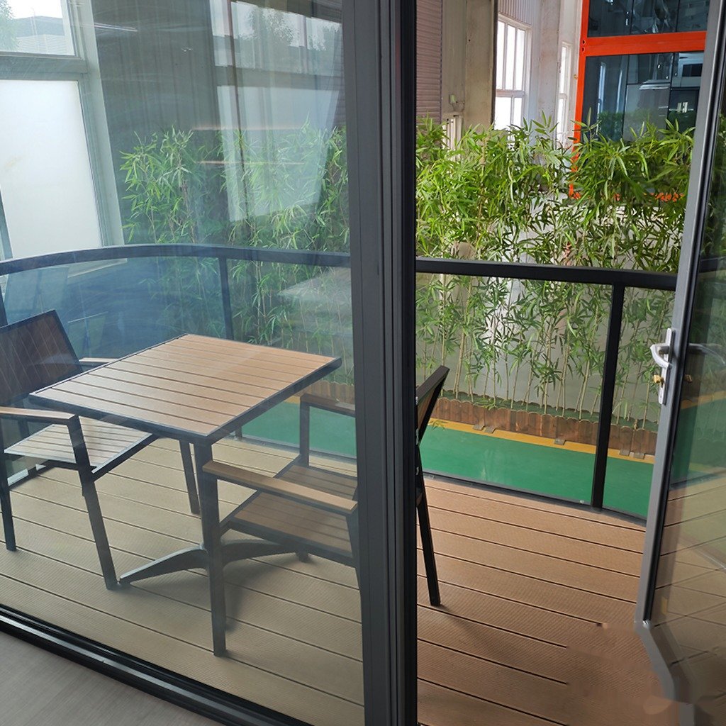 Capsule house hotel room interior with twin beds and curtained glass wall